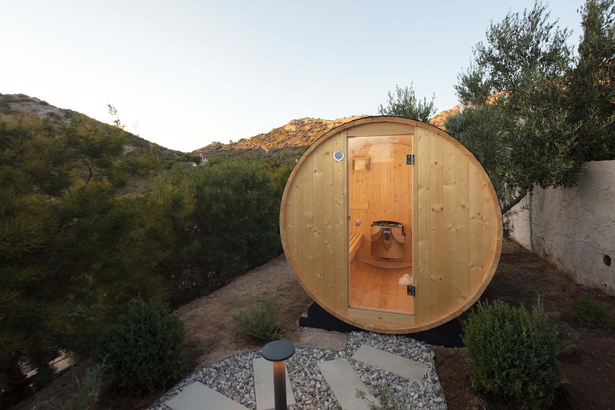Outdoor sauna among olive trees